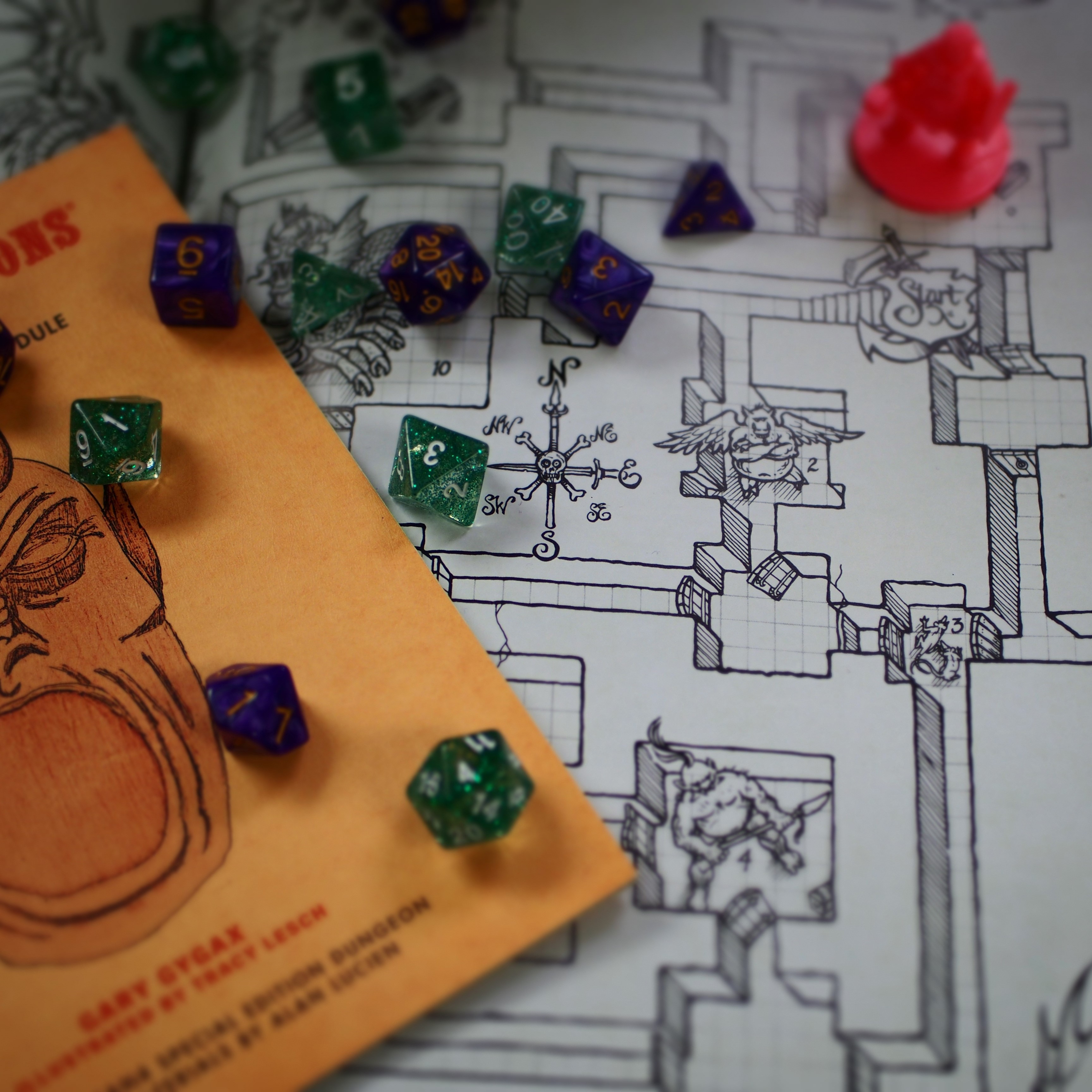 Polyhedral dice scattered across a hand-drawn dungeon map